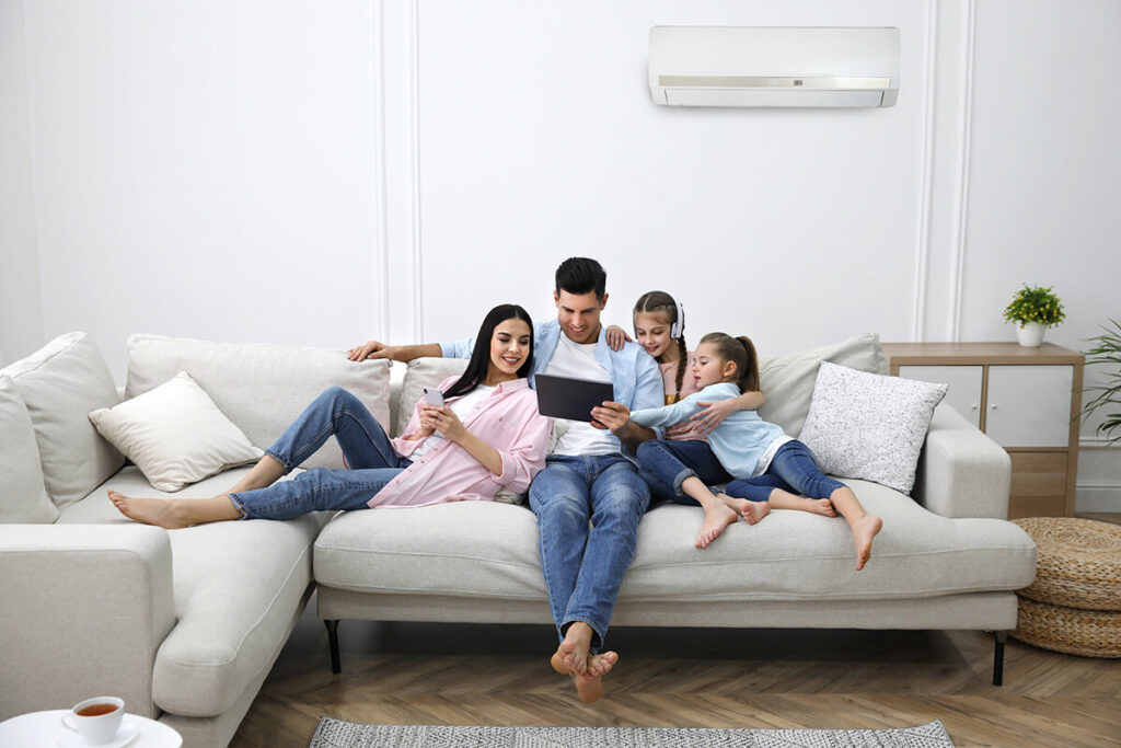 Family sitting on couch comfortably