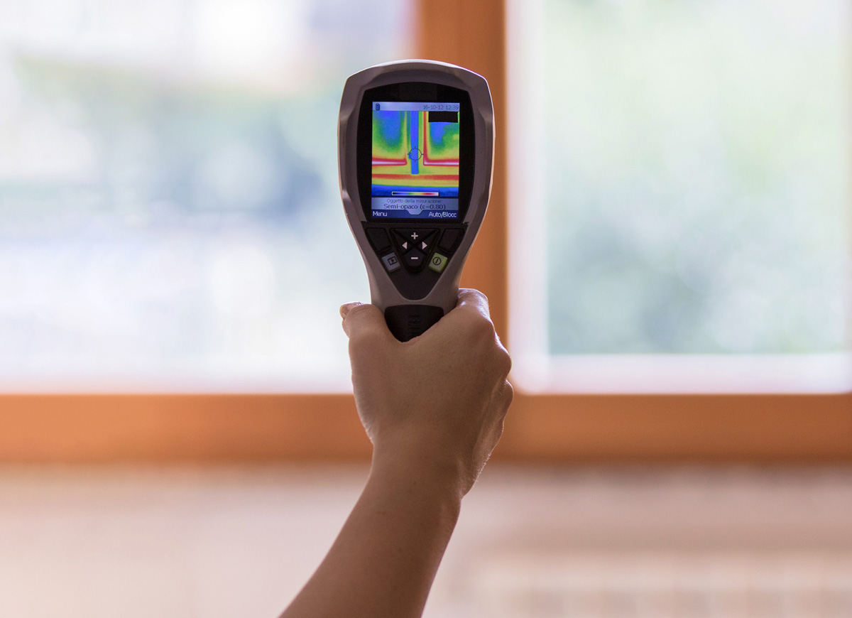 person holding performance tool next to window