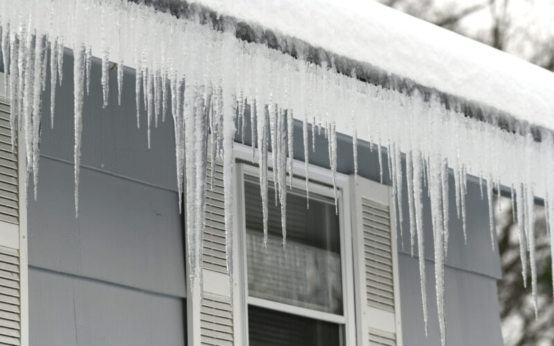 ice damming along the roof of a home