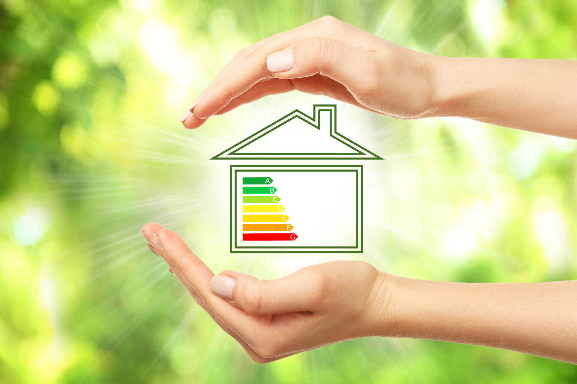 hands cupping a digital image of a home with yellow, green, and red lines showing energy efficiency levels