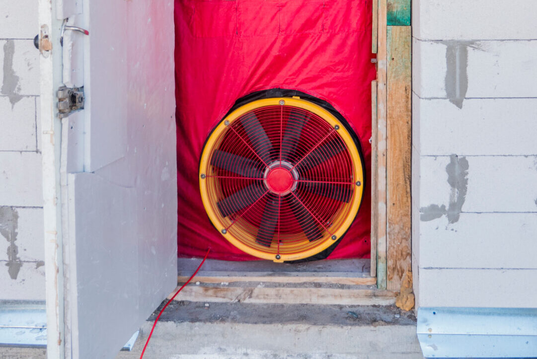 A blower door test setup in a doorframe.