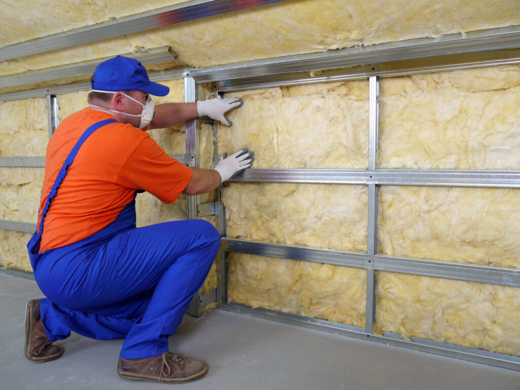A home professional installing new insulation 